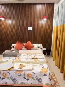 a bedroom with a large bed with a floral blanket at Mihira Homestays in Hanamkonda