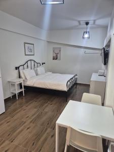 ein kleines Zimmer mit einem Bett und einem Tisch in der Unterkunft hotel vital in Rechovot