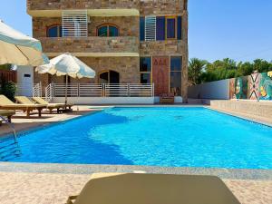 a large swimming pool in front of a building at Citadel Luxor in Luxor
