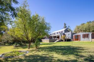 a house with a tree in the yard at Barrydale Bliss in Barrydale