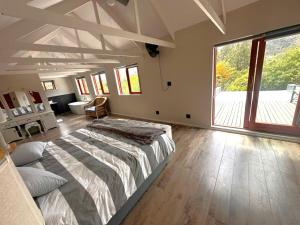 a bedroom with a large bed and a large window at Barrydale Bliss in Barrydale +16 photos