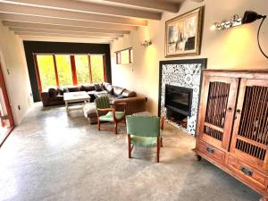 a living room with a couch and a fireplace at Barrydale Bliss in Barrydale