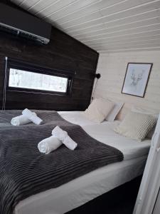 a bedroom with two beds with towels on them at Santa Elves Cabin in Rovaniemi