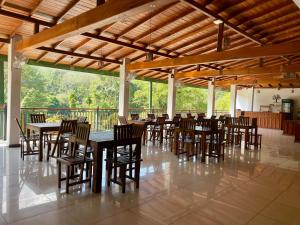 a dining room with tables and chairs in a building at Kitulgala Ebony Riverside Resort in Kitulgala