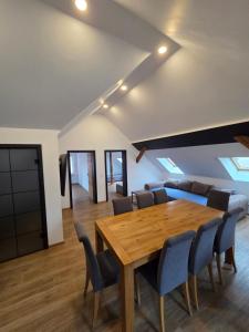 a dining room with a wooden table and chairs at Ferienwohnung NR4 DG Klima in Großräschen
