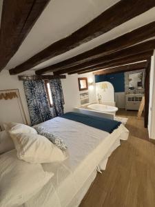 a bedroom with a large bed and a bath tub at Casa rural ‘’La Nuestra’’ in Bercimuel