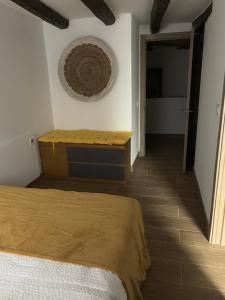 a bedroom with a bed and a basket on the wall at Casa rural ‘’La Nuestra’’ in Bercimuel