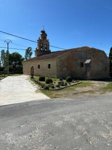 an old building with a tower on top of it at Casa rural ‘’La Nuestra’’ in Bercimuel