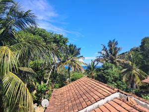 a roof of a house with palm trees in the background at Sunset Villa in Dickwella