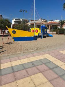 a playground with a yellow and blue play equipment at Wohnung in Chilches in Xilxes