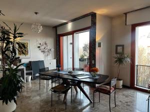 a living room with a dining room table and chairs at CASABELLA in Monza