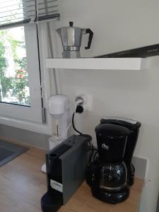 a coffee maker and a blender in a room at Eva's place in Lixouri