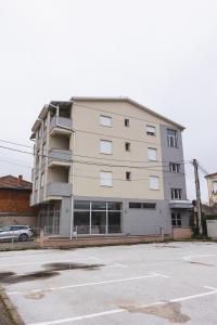 a large apartment building with a parking lot at Apartments Josif in Gevgelija