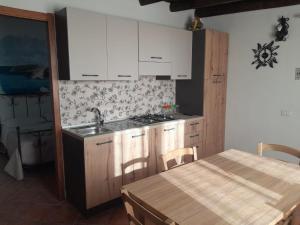 a kitchen with a sink and a stove and a table at Il Sole Di Lampedusa in Lampedusa +25 photos