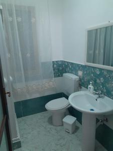 a bathroom with a toilet and a sink at Il Sole Di Lampedusa in Lampedusa