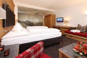 a hotel room with a large bed and a couch at Hotel Seehaus in Cuxhaven