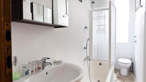 a white bathroom with a sink and a shower at Italianway-Colonnetta in Milan +14 photos