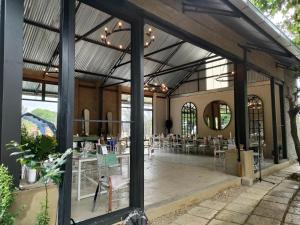 a building with a patio with tables and chairs at The House On The Hill in Lanseria