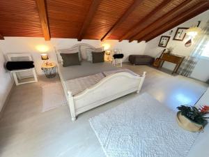 a bedroom with a large white bed in a room at Holiday home Metulum in Oštarije