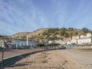 a view of a town with a mountain in the background at The Hayloft in Colwyn Bay