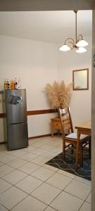 a kitchen with a refrigerator and a table and a chair at Hostel am Burgenring - kostenloser Parkplatz, Zentrum, Self Check-In, Küche in Schlitz +14 photos