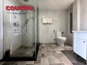 a bathroom with a shower and a toilet at CouCou Homestead II - Mini Hotel District 1 in Ho Chi Minh City