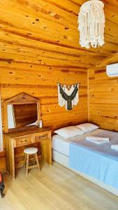 a bedroom with a bed and a desk in a cabin at Fullmoon Camp in Faralya +39 photos