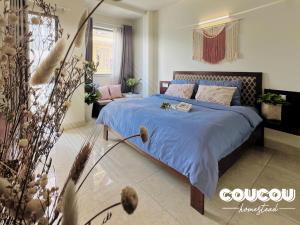 a bedroom with a bed with a blue comforter at CouCou Homestead II - Mini Hotel District 1 in Ho Chi Minh City +122 photos