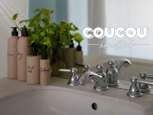 a bathroom sink with a faucet and some plants at CouCou Homestead II - Mini Hotel District 1 in Ho Chi Minh City