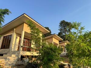 a house with trees in front of it at O Zen Resort in Ko Man Nai