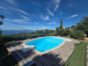 a swimming pool with a view of the ocean at Charmante Maison Vue mer Panoramique à Coti-Chiavari in Coti-Chiavari