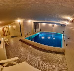a swimming pool in the middle of a building at Ostseeferienwohnung - Bossert in Kronsgaard
