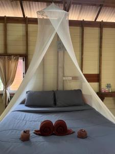 a bedroom with a bed with a mosquito net at Koh Jum Ozone Resort in Ko Jum +48 photos
