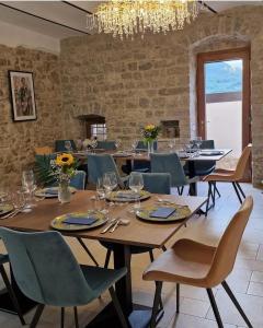 a dining room with tables and chairs and a chandelier at B&B Il Belvedere 2 in Guardialfiera