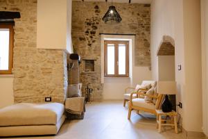 a bedroom with a bed and chairs in a room at B&B Il Belvedere 2 in Guardialfiera