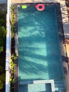 an overhead view of a swimming pool with a pink paddles at Villa Shanaya in Hikkaduwa