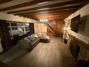 a living room with a couch and a fireplace at Lucy Cross Farm Cottage in Richmond