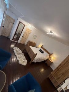 a bedroom with a bed and a couch and a chair at Lucy Cross Farm Cottage in Richmond