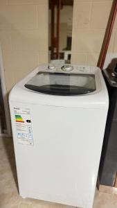a white washing machine sitting in a room at Refugio del Alma in Villa Anizacate