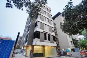 a tall building with a sign on the front of it at Hotel Samarth Elite Baner - Indian Guests Only in Pune