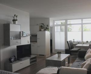 a living room with a couch and a tv at Ostseeferienparadies Heiligenhafen in Heiligenhafen