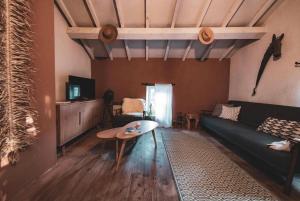 a living room with a couch and a table at MAISON ST LAURENT in Olargues