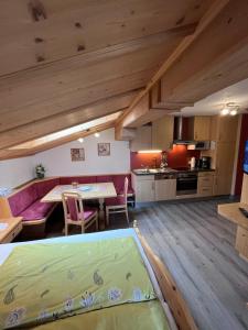 a large room with a kitchen and a dining room at Badmeisterhof in Leogang