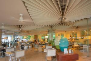 a restaurant with tables and chairs and a large ceiling at HighFloor Seaview Condo,Pool by the beach,Kitchen,Gym,WIFI in Jomtien Beach