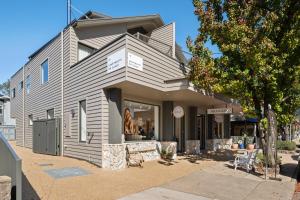 a store front of a gray building with a store at Apartment Two - Apartments on Gavan in Bright