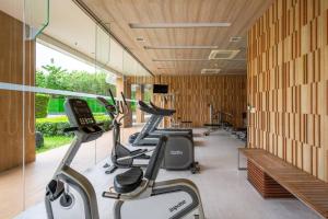 a gym with a row of treadms and elliptical machines at HighFloor Seaview Condo,Pool by the beach,Kitchen,Gym,WIFI in Jomtien Beach