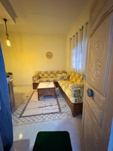 a living room with a couch and a table at Golden Dunes in Tozeur +1 photo