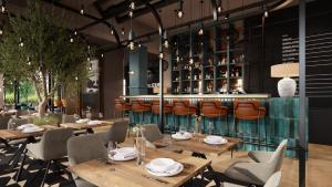 a restaurant with wooden tables and chairs and a bar at Hotel Euro in Pardubice