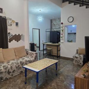 a living room with a couch and a table at Lamar home in Jakarta