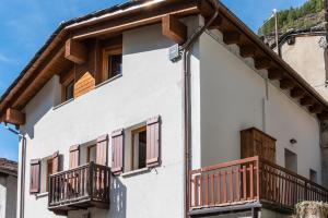 a house with balconies on the side of it at HelloCHALET - Casa Val - Your Walking Distance holiday in Valtournenche